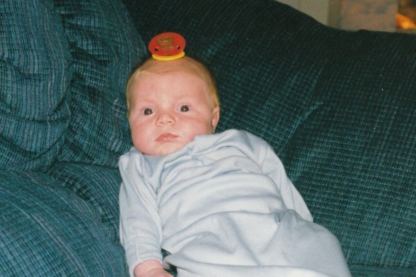 baby with binky of his head